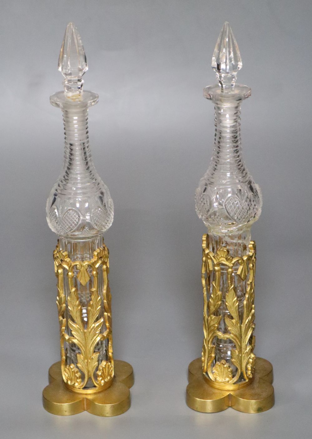 A pair of 19th century cut glass bottles and stoppers in ormolu stands (damage) and sundry other glassware
